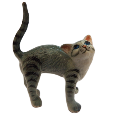 Cat figurine with a white face and gray body on a white background
