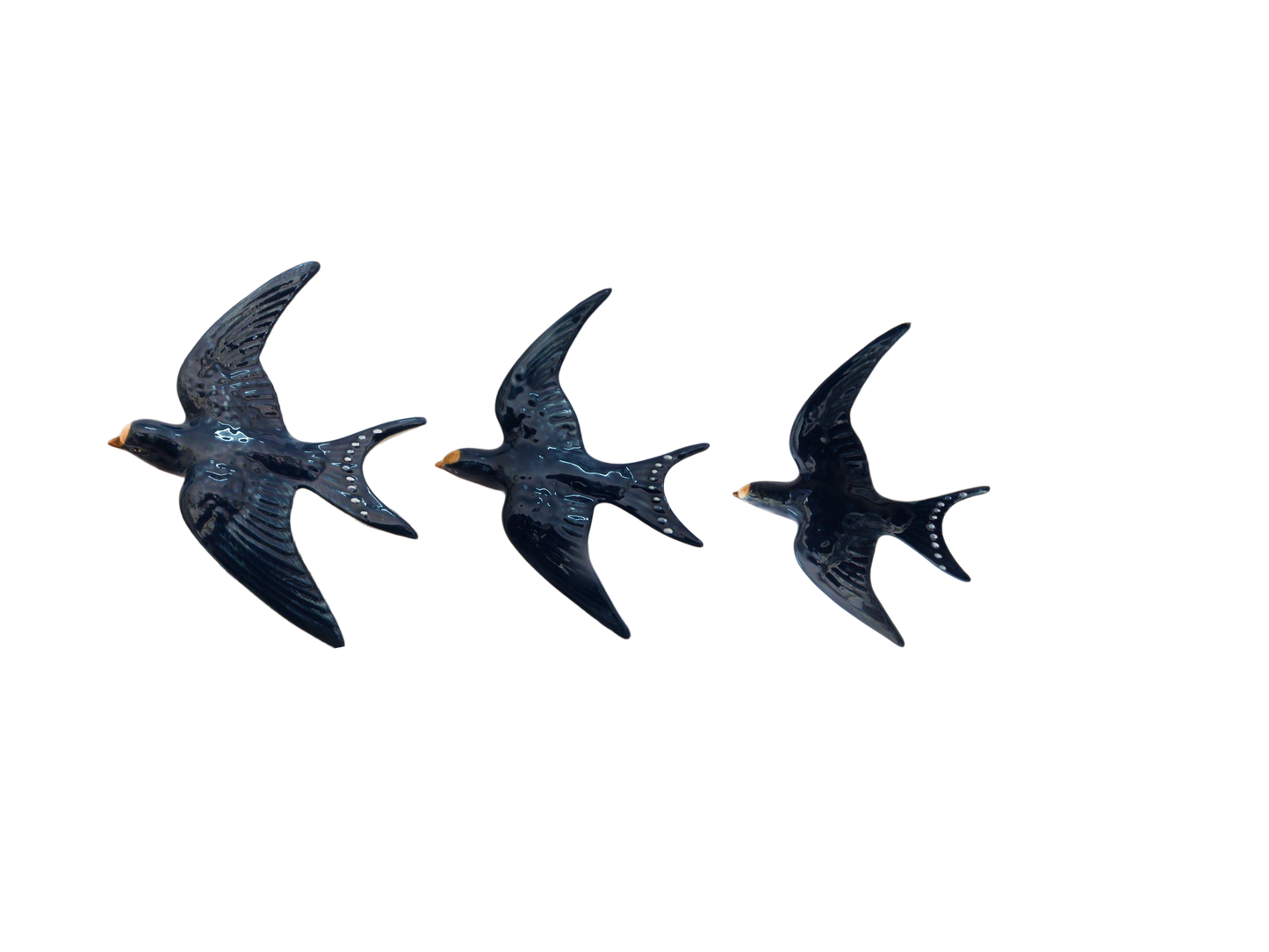 Three blue bird-shaped porcelain  Wall Swallow decorations on a white background