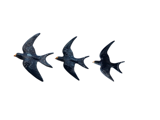 Three blue bird-shaped porcelain  Wall Swallow decorations on a white background