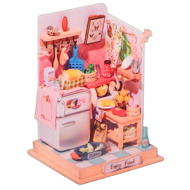 Miniature model of a kitchen with pink refrigerator and various items on a white background