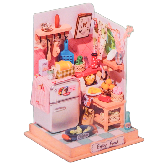 Miniature model of a kitchen with pink refrigerator and various items on a white background