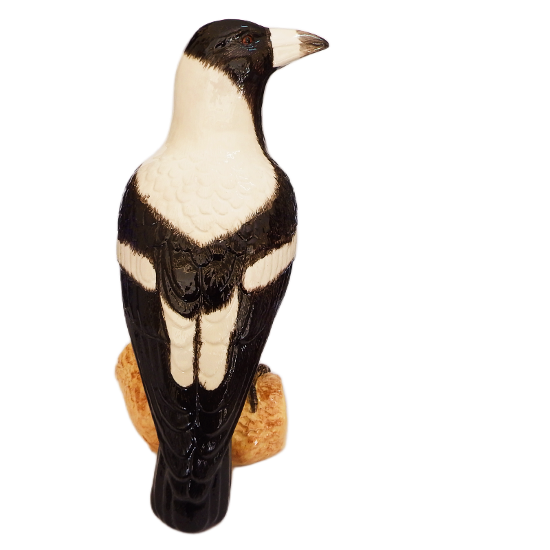 Australian Magpie bird figurine on a white background