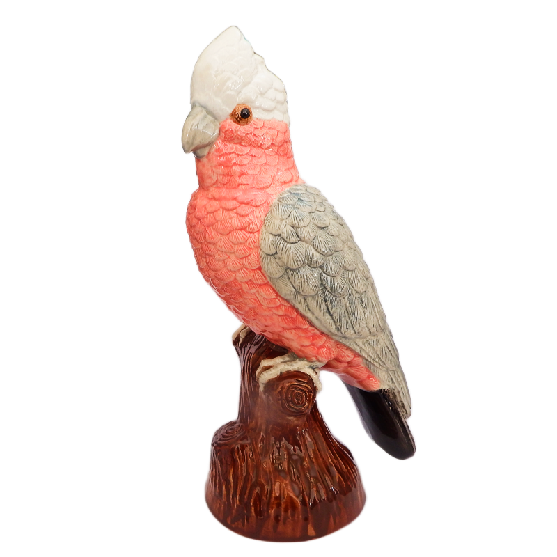 Statue of a galah cockatoo perched on a branch with a white background