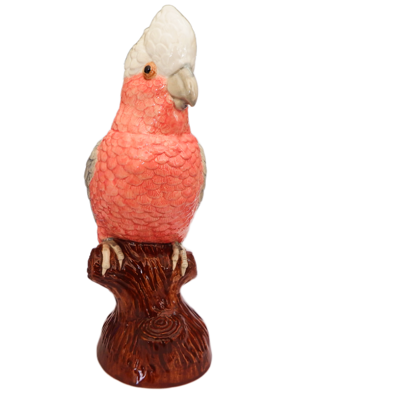 ceramic Galah Cockatoo figurine on a wooden perch against a white background
