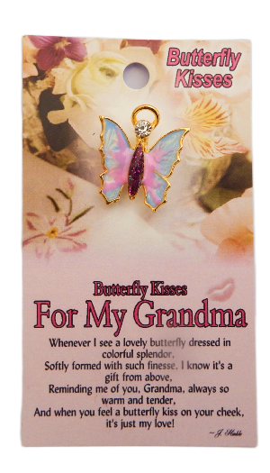 Butterfly-shaped charm on a decorative card with floral design and text.
