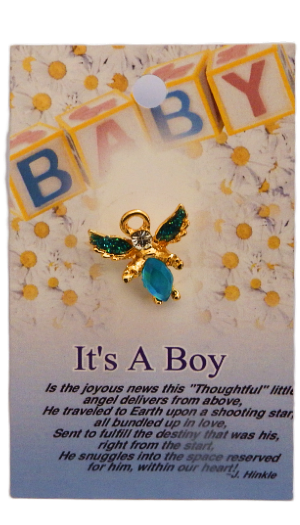 Gold and blue angel charm on a 'It's a Boy' card with baby blocks in the background.