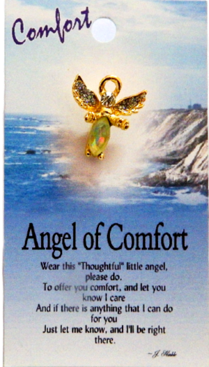Gold angel pin brooch on a card with ocean and cliff background