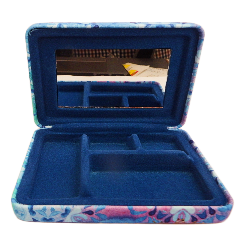 Blue jewelry case with floral pattern on a white background