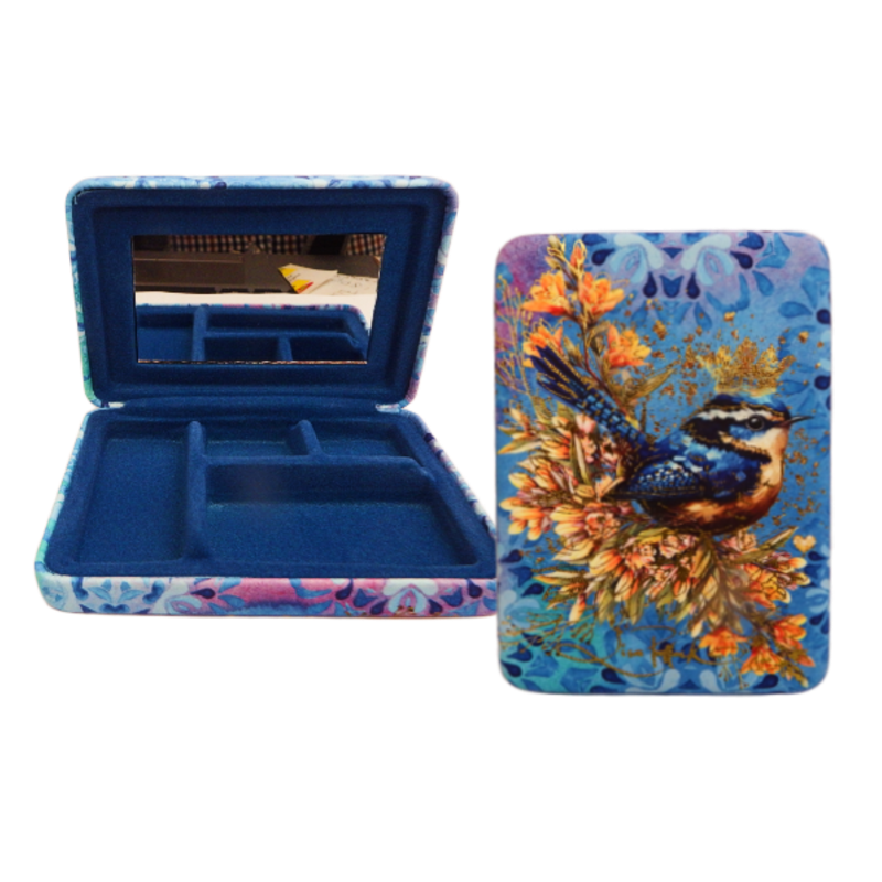 Makeup compact with floral and bird design on a white background