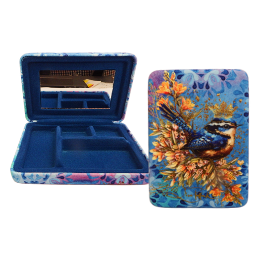 Makeup compact with floral and bird design on a white background