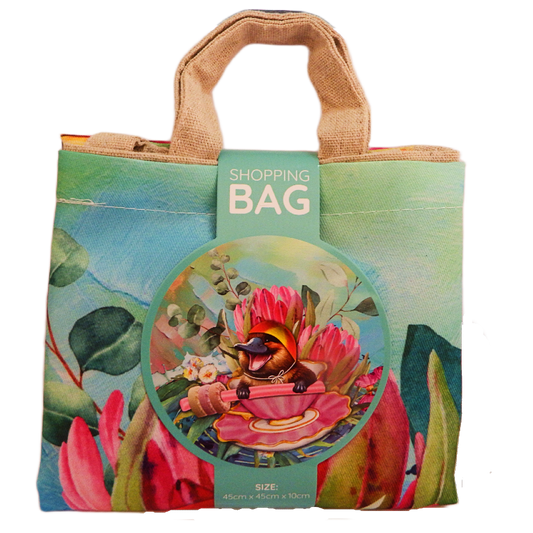 Colorful shopping bag with a design of a platypus and flowers, featuring a tag labeled 'Shopping Bag'.