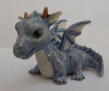 small blue tragon on white surface