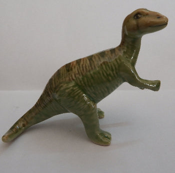 green dinosaur figurine on white backgraund
