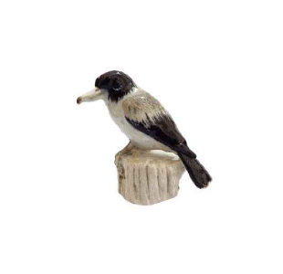 A small  Australian butcher bird  bird figurine perched on a faux tree stump, featuring a black head and back, a white underbelly, and gray wings, isolated on a white background.