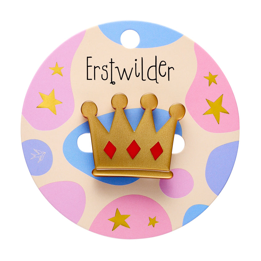 Gold crown-shaped brooch on a colorful card with 'Erstwilder' branding