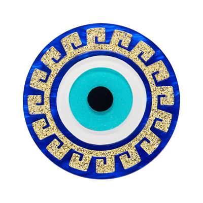 Evil eye charm with blue, white, and gold colors on a white background