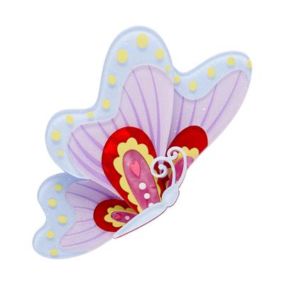 Colorful butterfly-shaped object with polka dots on a white background