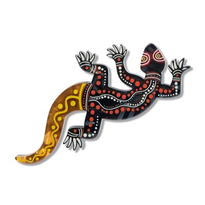 Decorative brooch of a lizard with Aboriginal art patterns on a white background