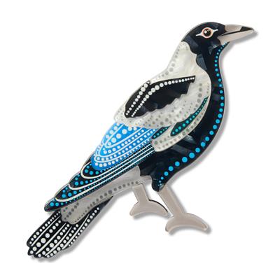 Decorative magpie erstwilder brooch with blue, black, and white colors on a white background