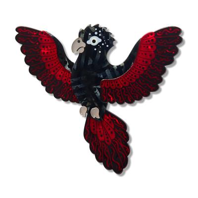Black and red bird-shaped decorative brooch item on a white background