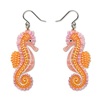 Seahorse-shaped earrings on a white background