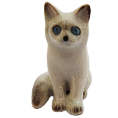 Ceramic cat figurine with blue eyes on a white background