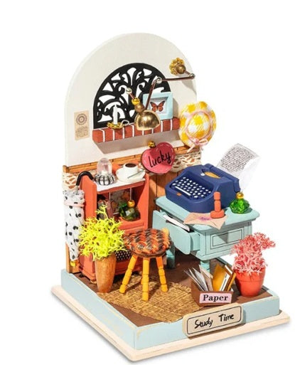 Miniature model of a study room with furniture and decor on a white background