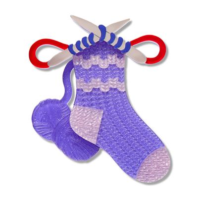 knitting needles & Purple and pink sock with red and white accents on a white background
