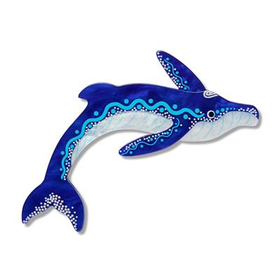 Decorative whale brooch with blue and white patterns on a white background