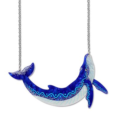Blue and white whale-shaped pendant on a chain against a white background