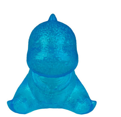 A translucent blue dinosaur-shaped bath bomb or bath sponge on a solid white background.