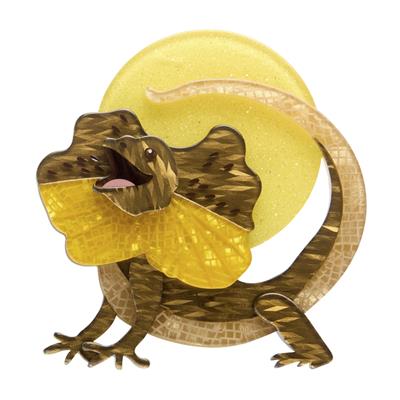 Decorative Frill Neck lizard brooch with a yellow shell on a white background