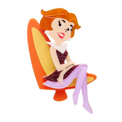 Jane Jetson Erstwilder brooch character sitting on a chair with a white background