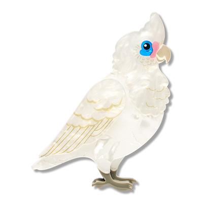 Whimsical white cockatoo bird brooch with blue eye and gold beak detail