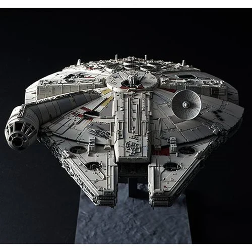 Model of the Millennium Falcon spaceship on a reflective surface with a dark background