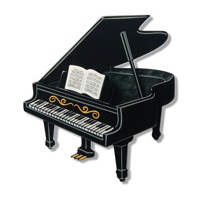 Black grand piano with a sheet music score book on the music stand on a white background