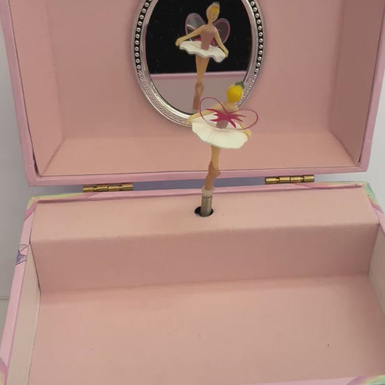 move rainbow unicorn musical jewelry box with pink lining with rotating fairy to the tune of swan lake with a mirror behind