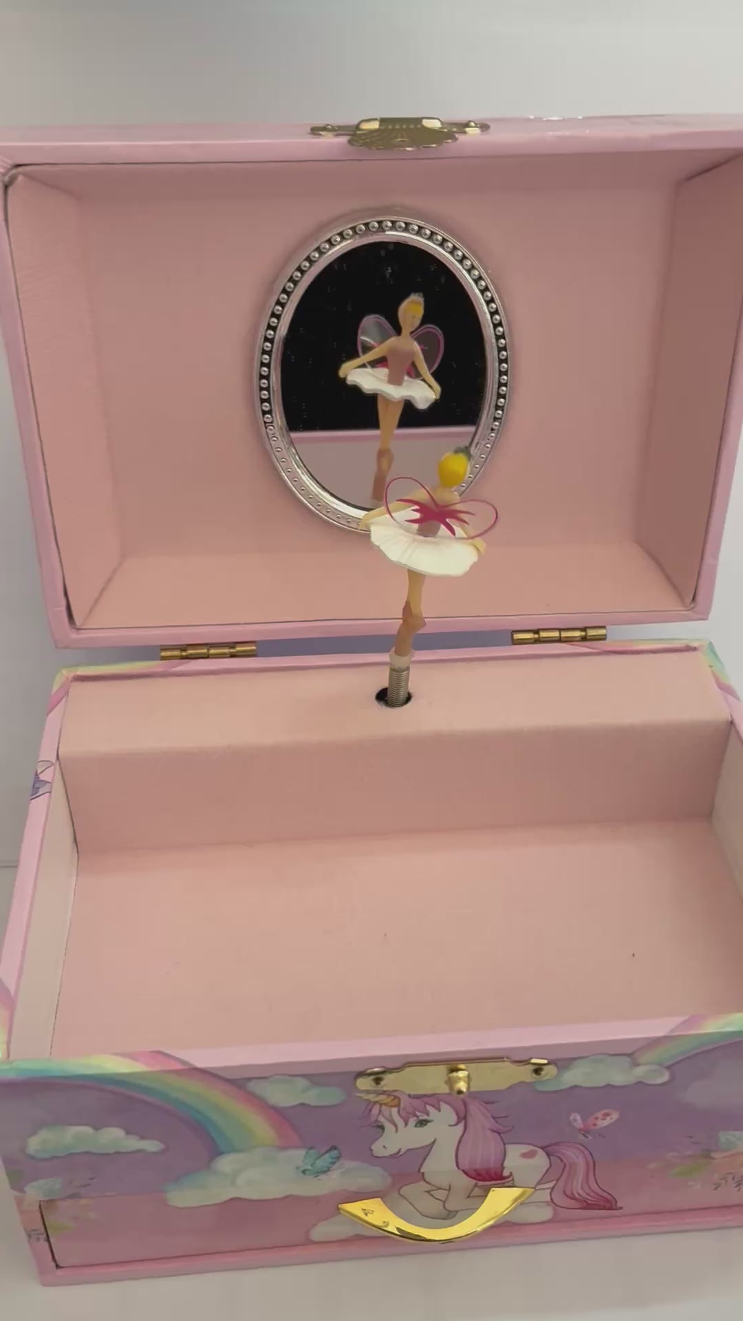 move rainbow unicorn musical jewelry box with pink lining with rotating fairy to the tune of swan lake with a mirror behind