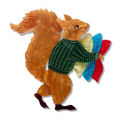 Decorative squirrel erstwilder brooch of wearing a sweater with colorful tail feathers on a white background