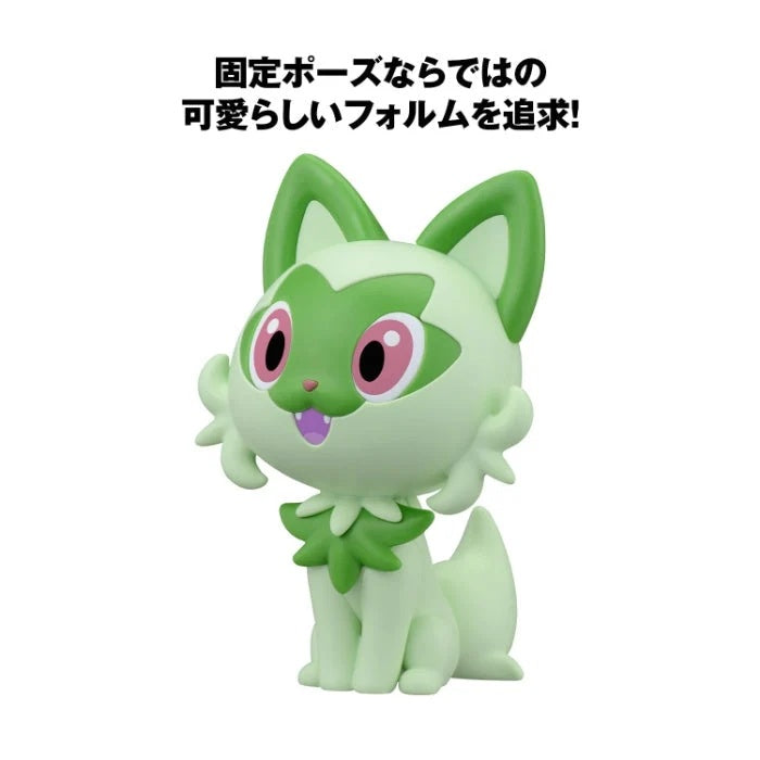 A light green and white Pokémon character figurine with green ears, pink eyes, and a purple mouth, shown on a white background with Japanese text above.