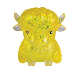 A small translucent yellow bull figurine filled with glitter, featuring small white horns and black eyes, set against a plain white background.